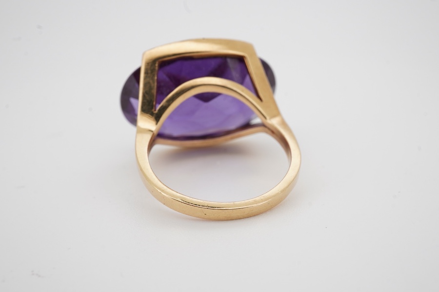 An 18k and single stone oval cut synthetic colour change corundum set dress ring, size P, gross weight 10.6 grams. Condition - good